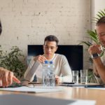 Business people discussing new project in office. Team of business professionals having a meeting