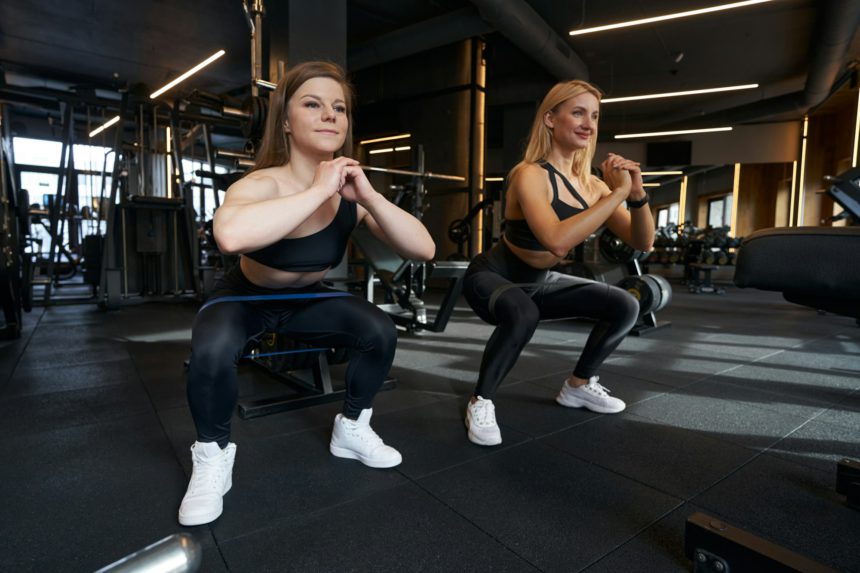 Two women doing resistance training at gym